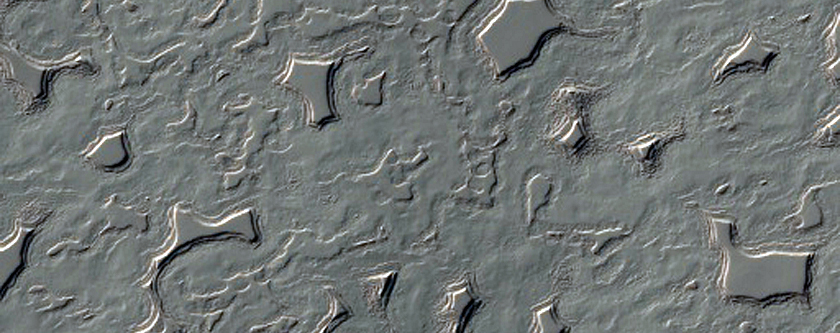 Swiss Cheese-Like Terrain Seen To Be Changing in MOC Images