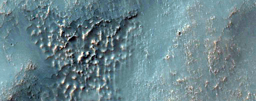 Layered Dissected Mantle Terrain and Channel Breaching Crater Rim