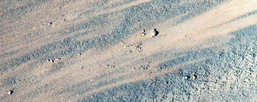 Oblique Impact Exposing Bedrock within A Libya Montes Massif