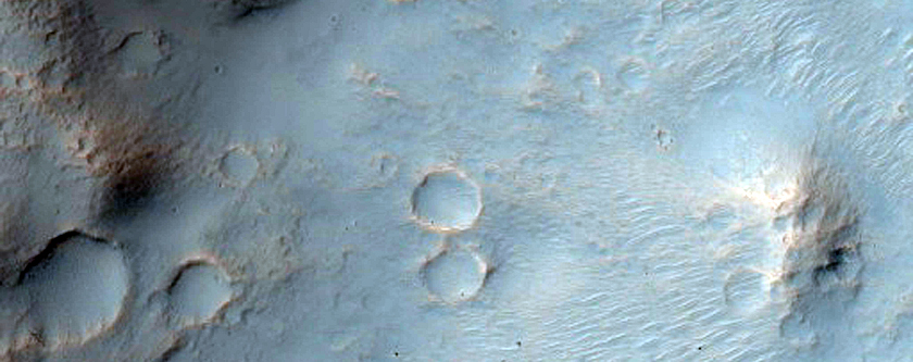 Impact Crater with Lobate Eject on Fracture Systems Near Mare Sirenum