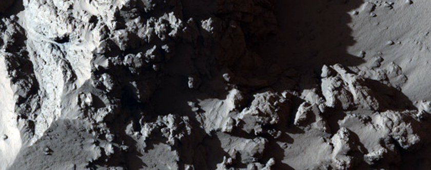 Mesa in Noctis Labyrinthus with Layers Shedding Boulders