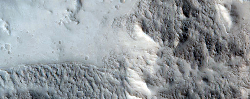 Distal Stratigraphy of Alba Patera Exposed in An Impact Crater