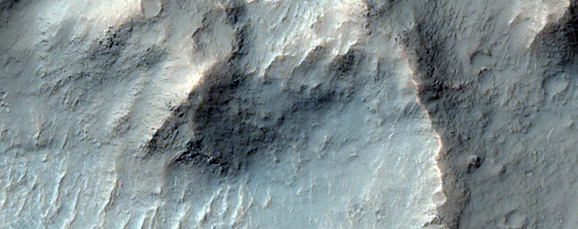 Layered Bedrock Exposed in Central Uplift of Crater in Thaumasia Planum