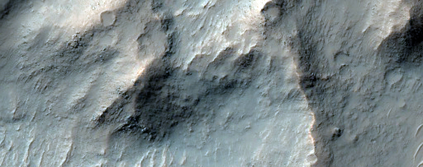 Layered Bedrock Exposed in Central Uplift of Crater in Thaumasia Planum