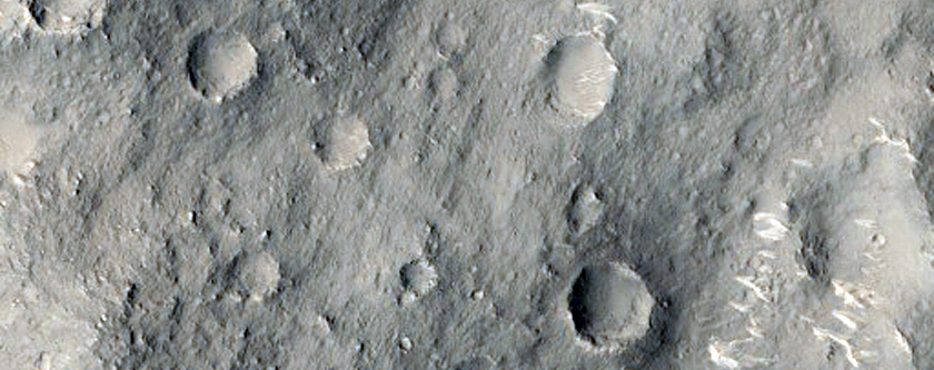 Ejecta Intersecting the Crater Rim in a Small Unnamed Crater
