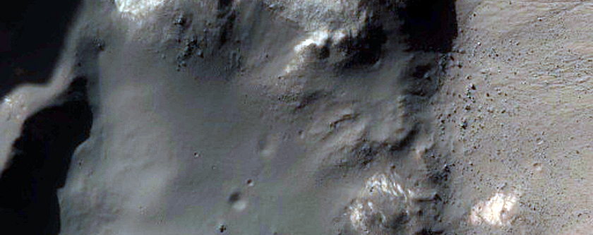 Fresh Crater with Both Light-Toned Outcrops and Gullies