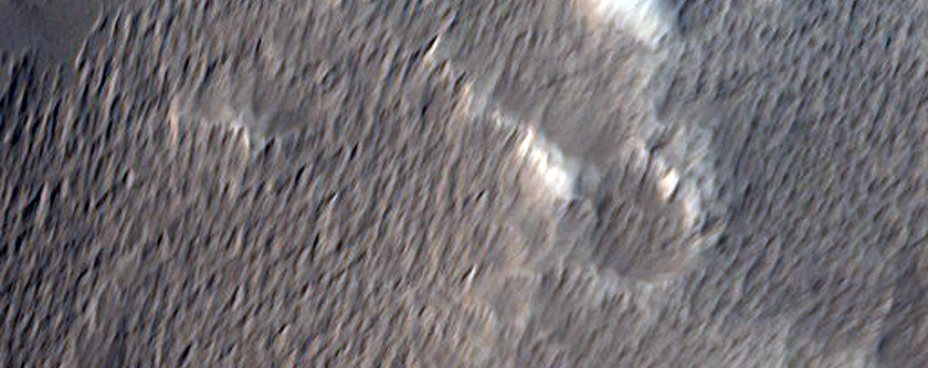 Uranius Tholus Stratigraphy Exposed in An Impact Crater
