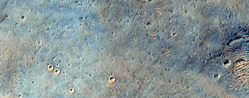 Light-Toned Outcrops Exhumed from Under Dark Material in Arabia Region