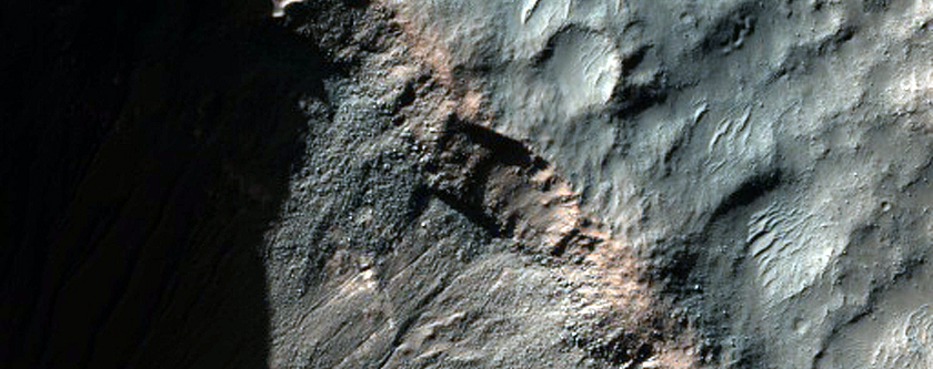 Gullies and Light-Toned Outcrops in Crater Wall