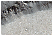 Slope Streaks Diverted around Crater in Trough Wall