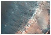 Impact into Possible Olivine-Rich Ridged Plains on Floor of Huygens Crater