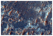 Olivine and HCP Signatures on Floor of Filled Crater West of Huygens Crater