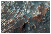 Uplift of Layered Materials from the Intersection of Two Craters