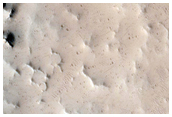 Well-Preserved 8-Kilometer Diameter Crater Near Tharsis Tholus