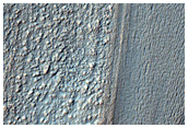 Lobate Feature on Slope on Northwest Hellas Region Rim