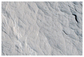 Layered Materials and Blocks in Olympus Mons Aureole