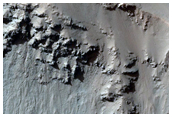 Gully with Light-Toned Material in Walls in Noachis Terra