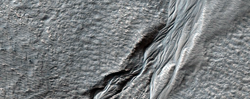 Crater in Aonia Terra