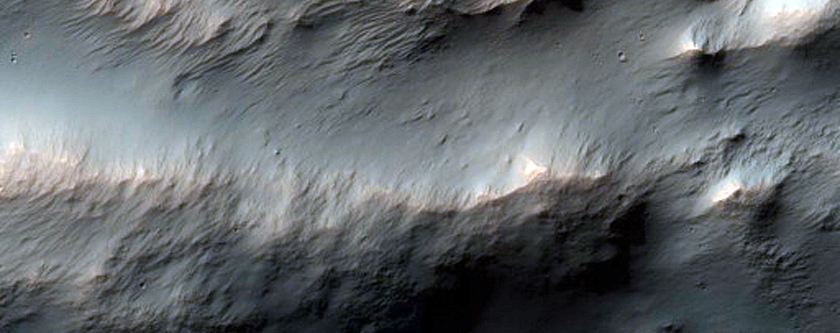 Impact Crater Exposing Bedrock