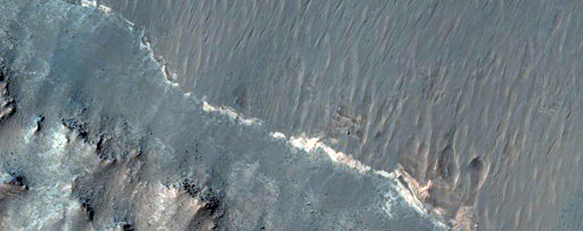 Light-Toned Hydrated Material along Melas Chasma Wallrock and Floor