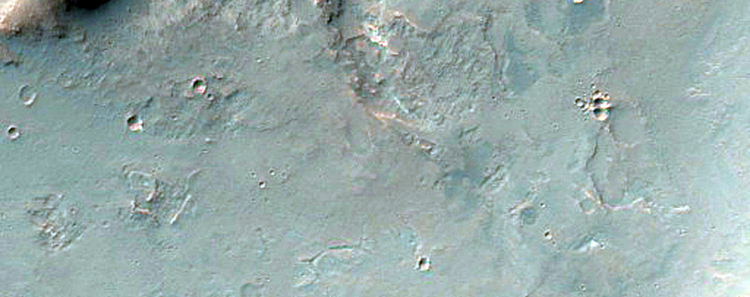 Light-Toned Material along Coprates Chasma Wallrock and Plateau