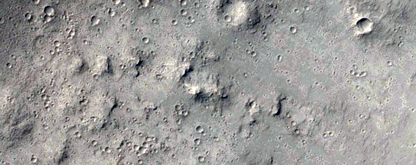 Layered Yardangs Armored by Crater Ejecta