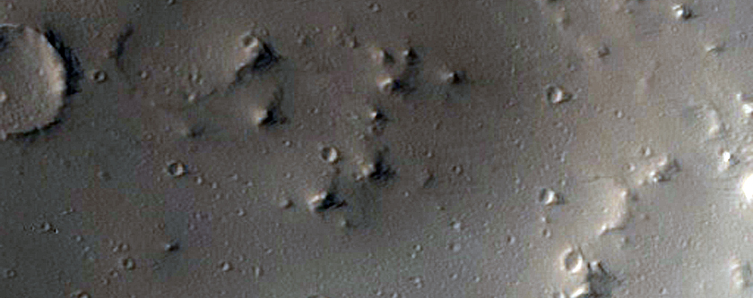 Asymmetrical Ejecta From Elliptical Crater East of Uranius Patera