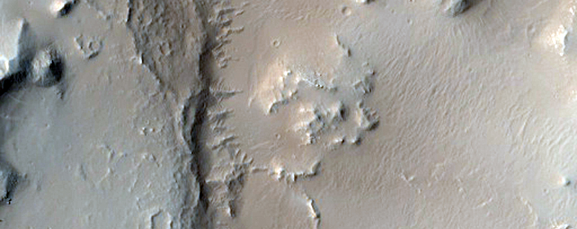 Crater with Disrupted Interior and Channel Exiting South End