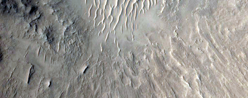 Crater with Central Uplift and Bedrock Layers Exposed in Walls