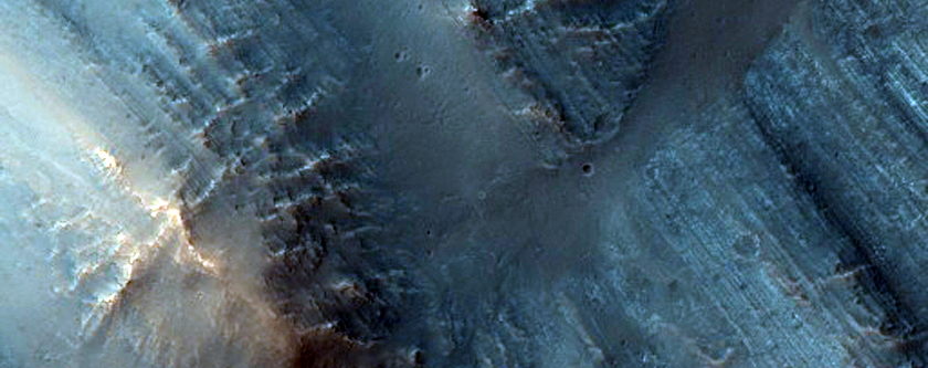 Light-Toned Tilted Layering in Central Peak of Oudemans Crater