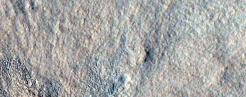 Northern Plains Crater with Possible Outcrop

