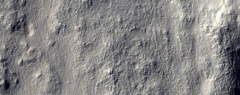 Layered Deposits in Small Crater in Terra Cimmeria 
