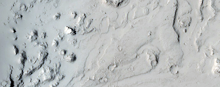 Lava Flow Through Breached Crater Rim in Tartarus Montes