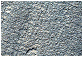 Fan-Like Features on North Side of Crater Ejecta Near Reull Vallis