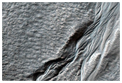 Crater in Aonia Terra