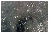 Crater Ejecta Material in Contact with Mesas and Buttes