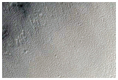Crater with Rampart-Like Ejecta Exposed in Cross Section