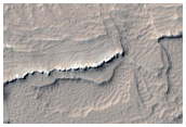 Stratified Material in Gigas Fossae Region