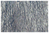 Striated Material in Crater Visible in THEMIS Image V17605022