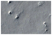 Western Arabia Intercrater Layered Material and Parallel Linear Ridges