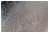 Stratified Material in the Gigas Fossae Region