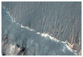 Light-Toned Hydrated Material along Melas Chasma Wallrock and Floor