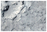 Cratered Cones with Divergent Wakes Near Grjota Valles