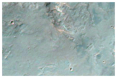 Light-Toned Material along Coprates Chasma Wallrock and Plateau