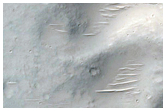 Pitted Materials on Floor of 90-Kilometer Diameter Crater