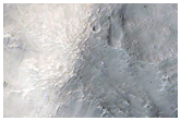 Recent Impact Crater on the Rim of a Much Larger Crater