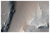 Crater with Disrupted Interior and Channel Exiting South End