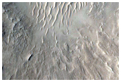Crater with Central Uplift and Bedrock Layers Exposed in Walls