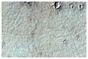 Flows and Terraces Overlapping Crater Ejecta South of Marte Vallis