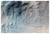 Crater on Ius Chasma Floor